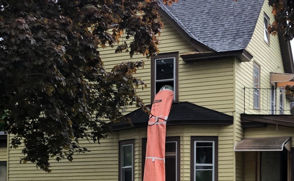 Modular construction debris chute in use on job site